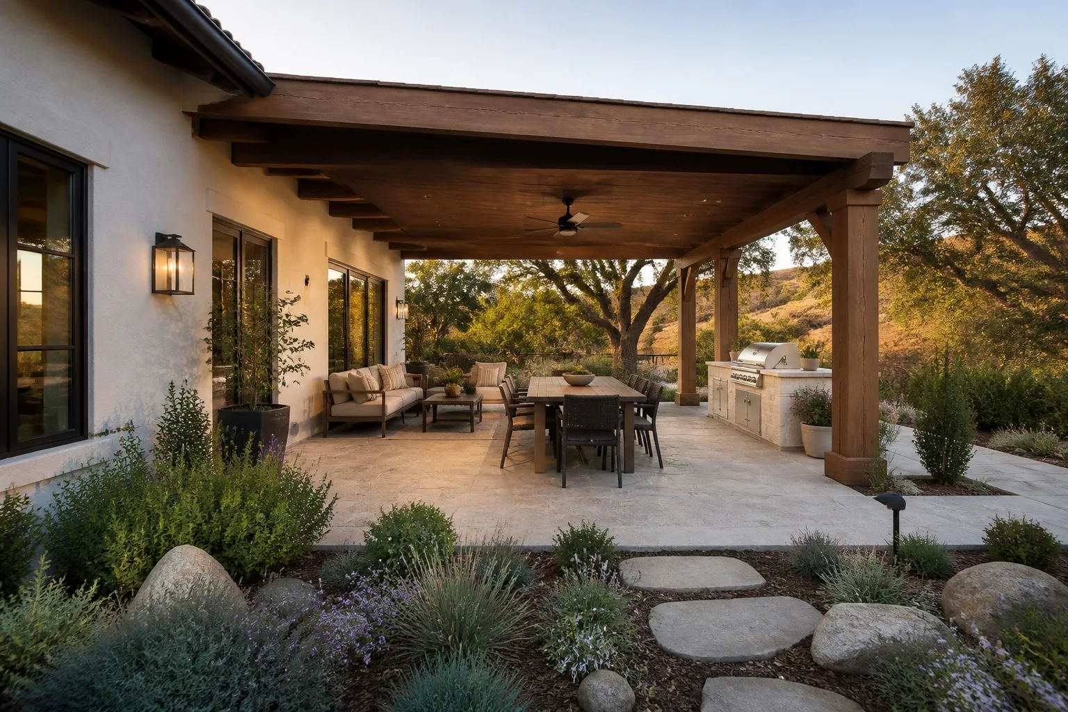 Complete covered patio concept with dining, seating, outdoor kitchen, and oak-tree view